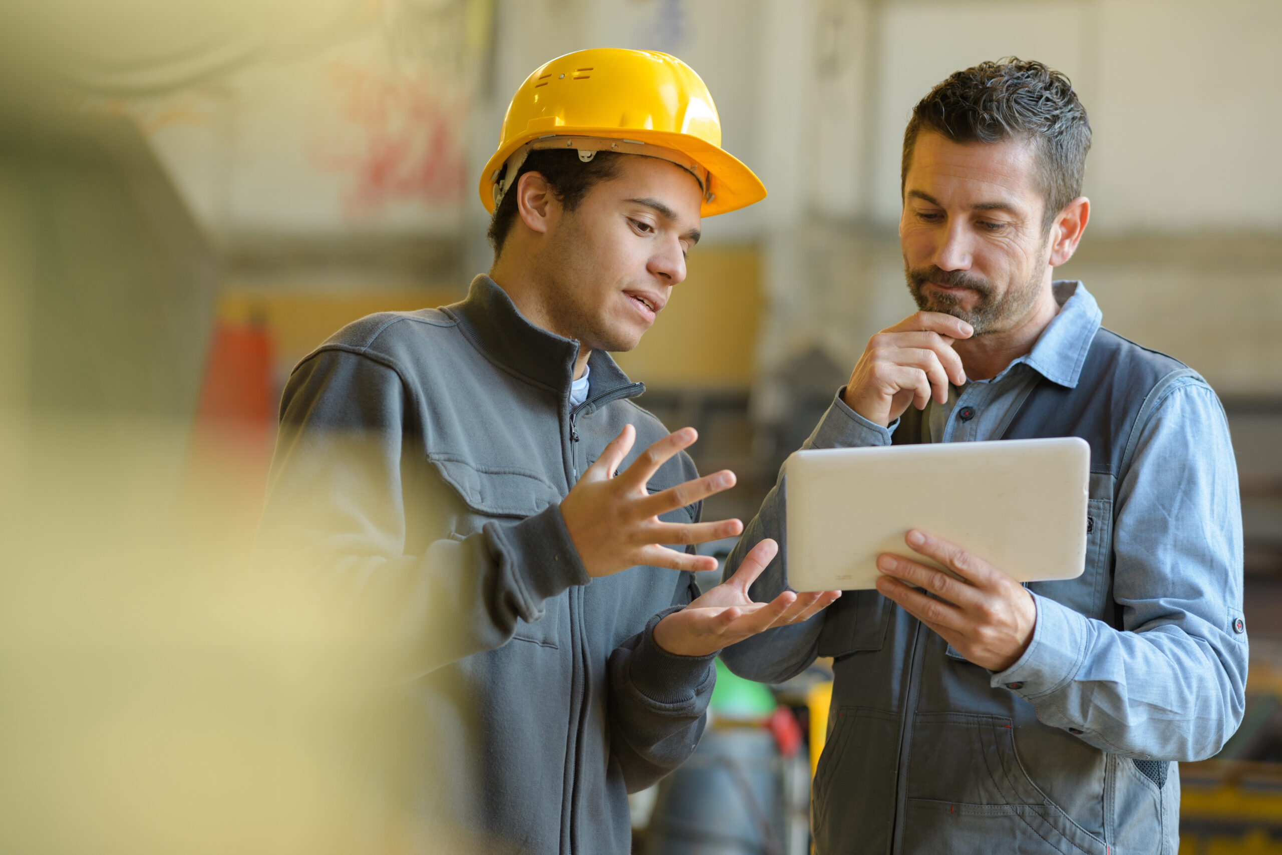boss and worker checking results on the tablet boss and worker checking results on the tablet